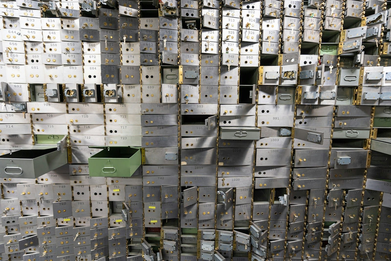 Mur de coffres et casiers métalliques, certains entrouverts